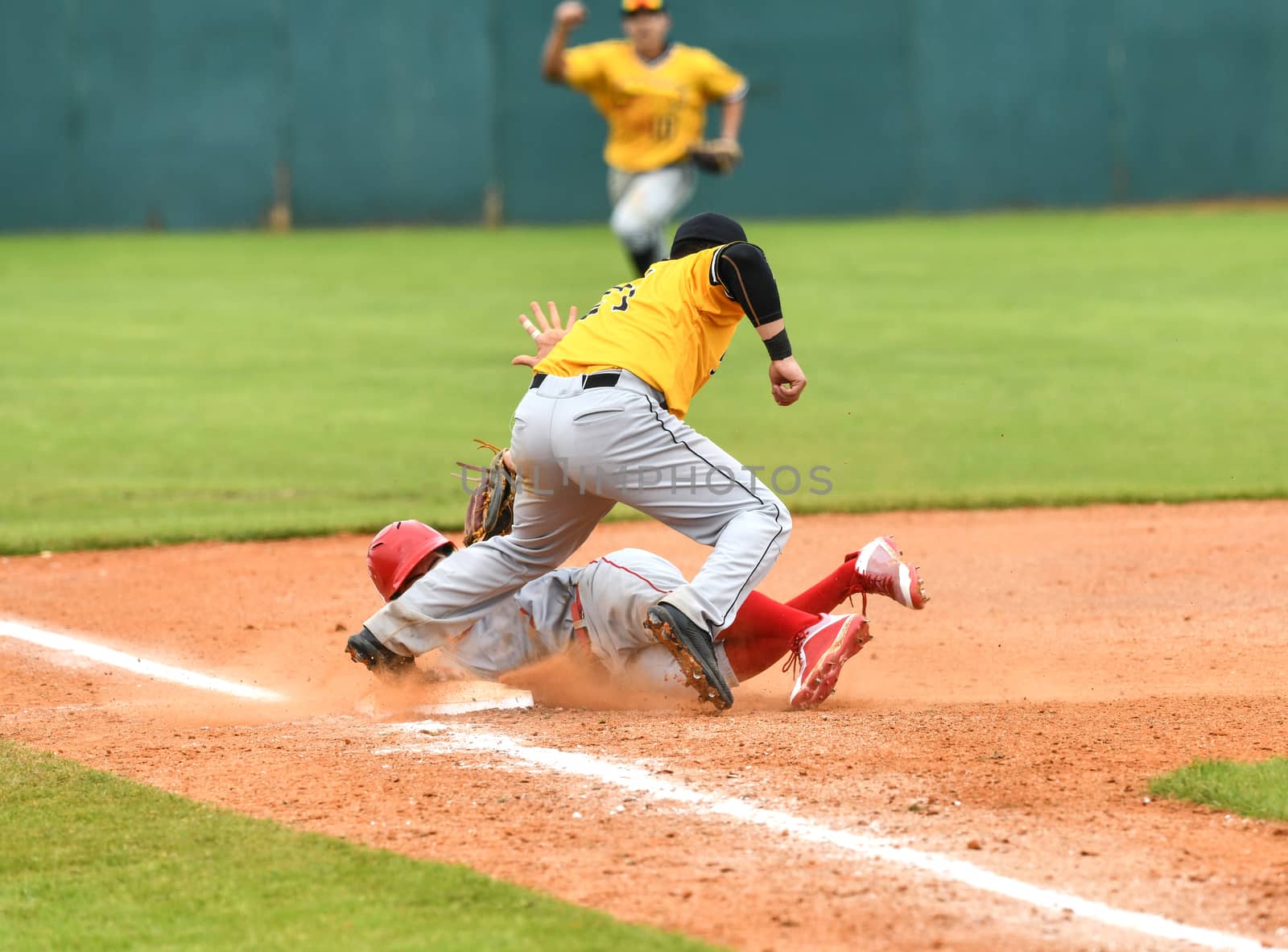 Action photo of high school baseball players making amazing plays during a baseball game