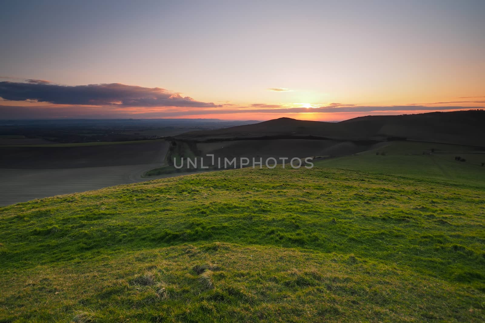 Sunset from the top of Knap Hill looking across the Vale of Pewsey and Salisbury Plain, North Wessex Downs, Wiltshire, UK
