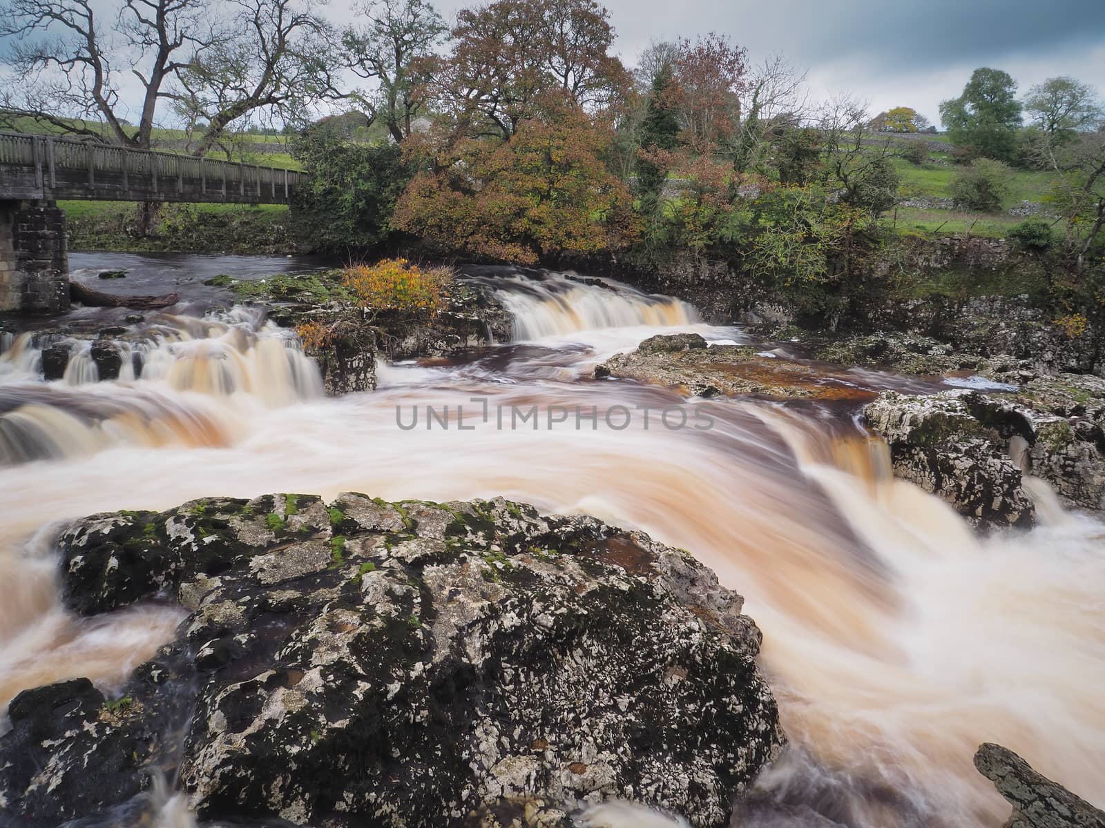 Torrent of water cascading over Linton Falls on the River Wharfe near Grassington, Wharfedale, Yorkshire Dales, UK