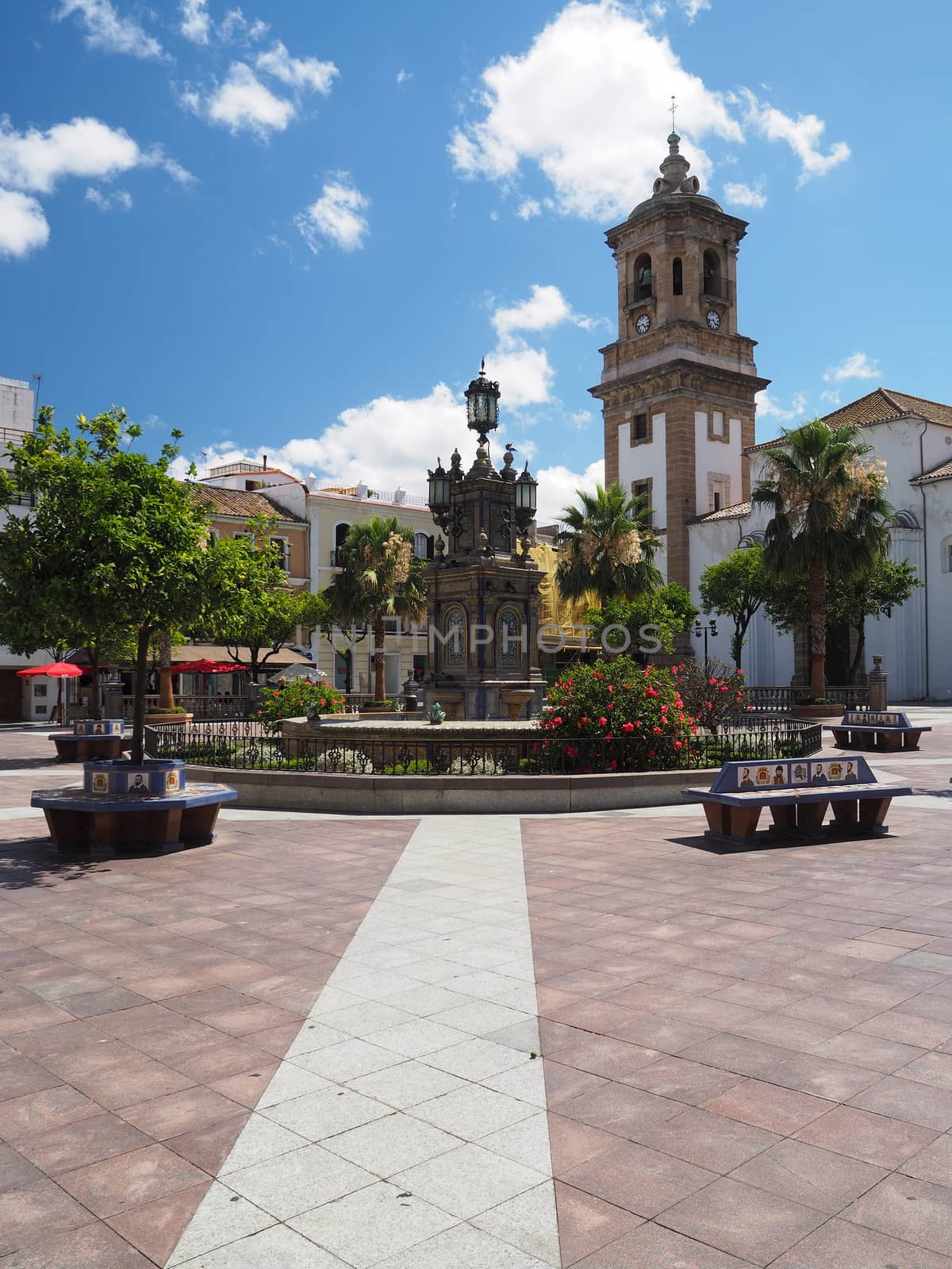 Looking across the Plaza Alta and the colorful tiled fountain and seating to the Iglesia de Nuestra Senora de la Palma, or The Church of Our Lady of the Palm, Algeciras, Andalucia, Spain