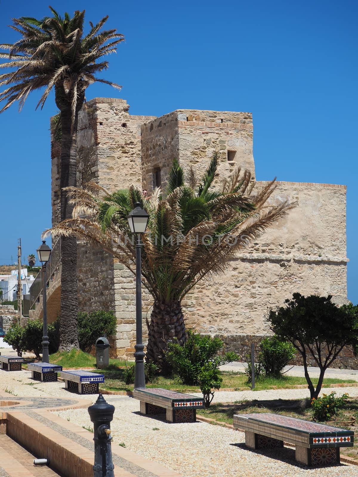 Stone tower and colorful tiled seating at the Castillo de Tarifa Castillo de Guzman el Bueno, or Castle of Tarifa, Tarifa, Andalucia, Spain