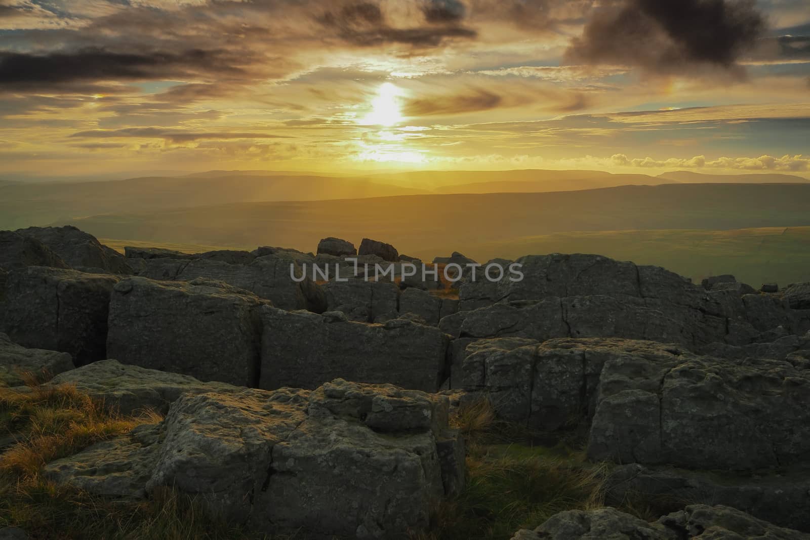 Stunning sunset from the rocky outcrop at the top of Great Whernside overlooking Wharfedale, Yorkshire Dales, UK