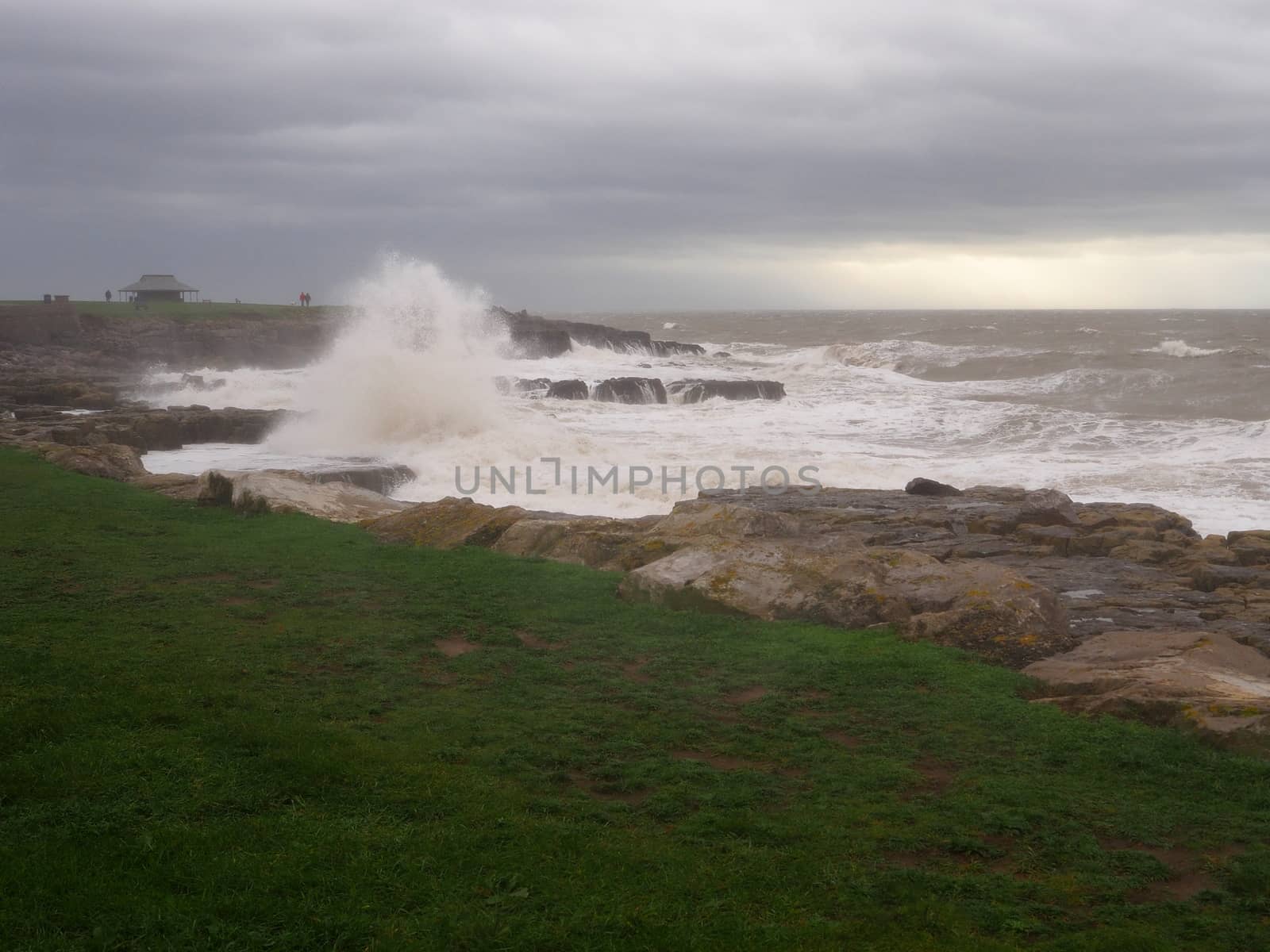 Porthcawl on a dramatic stormy day with waves crashing onto rocks, South Wales