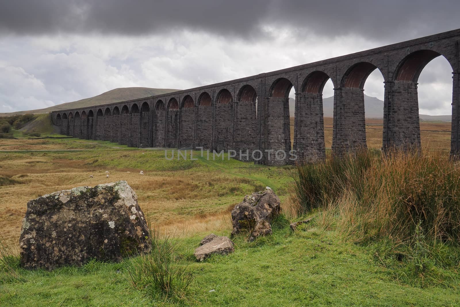 Overcast moody sky above the iconic Ribblehead Viaduct or Batty Moss Viaduct which carries the Settle to Carlisle railway across Batty Moss in the Ribble Valley, Yorkshire Dales, UK