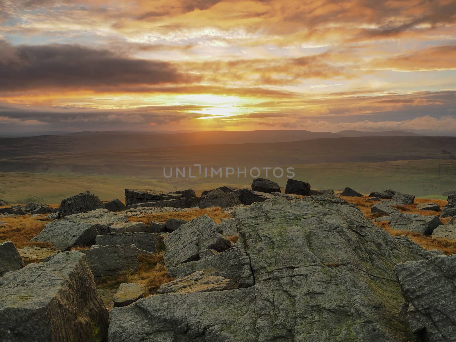 Stunning sunset from the rocky outcrop at the top of Great Whernside overlooking Kettlewell, Wharfedale, Yorkshire Dales, UK