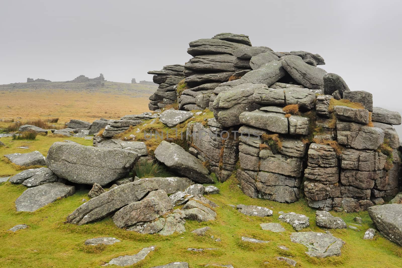 Middle Staple Tor looking up to Great Staple Tor with mist rolling in over the top, Dartmoor National Park, Devon, UK