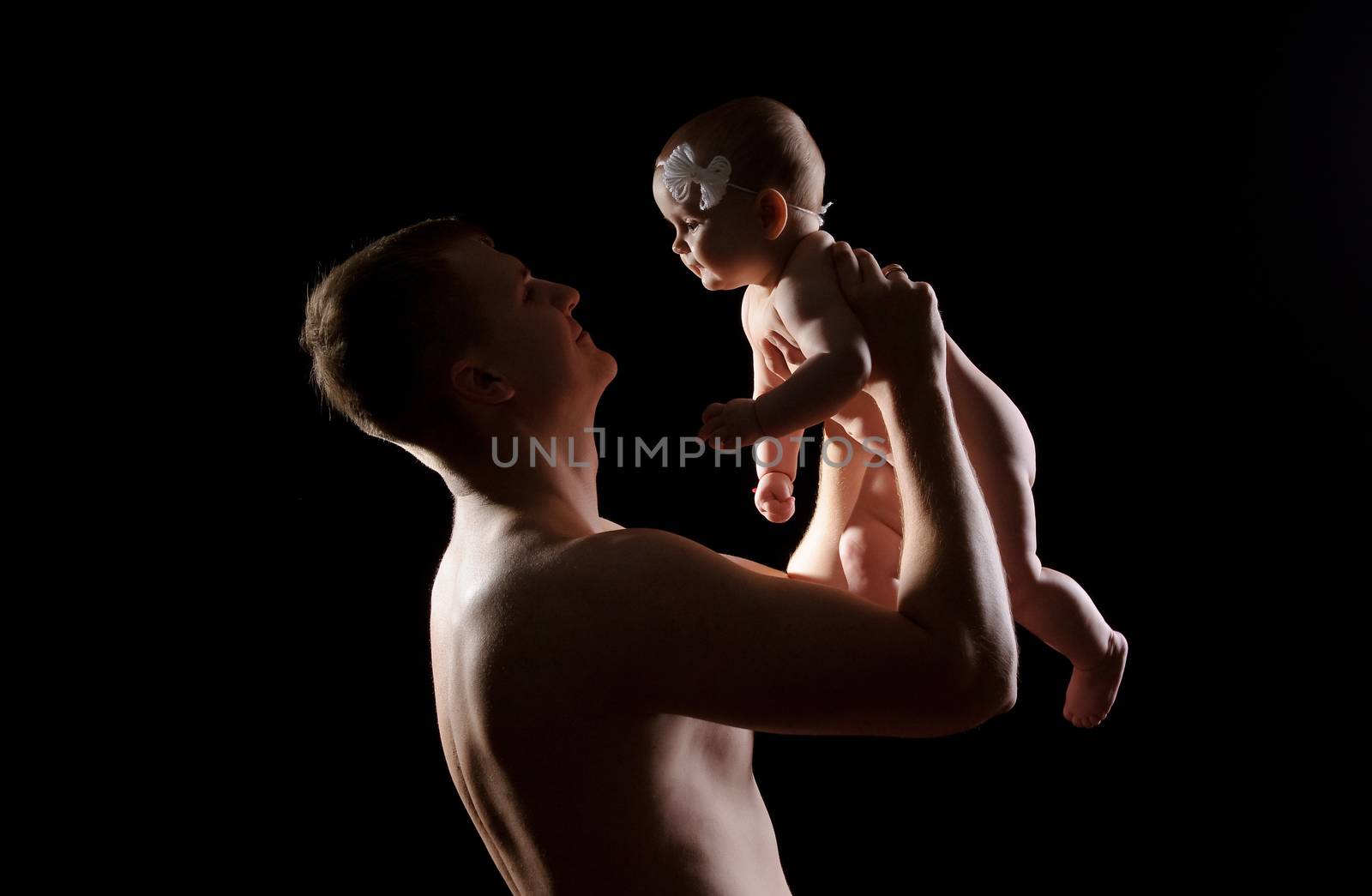 Male holding nice infant baby girl. Daughter on father's arms. Human growth and development. New generation. Cheerful man and his baby. New life concept. Silhouette