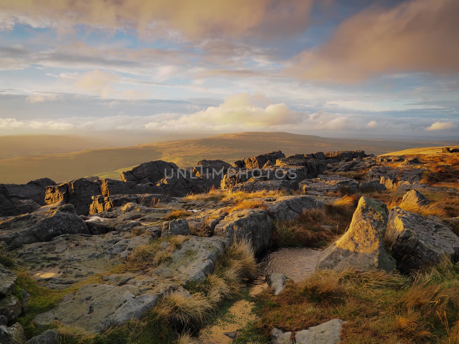 Sunset from the rocky outcrop at the top of Great Whernside overlooking Wharfedale, Yorkshire Dales, UK