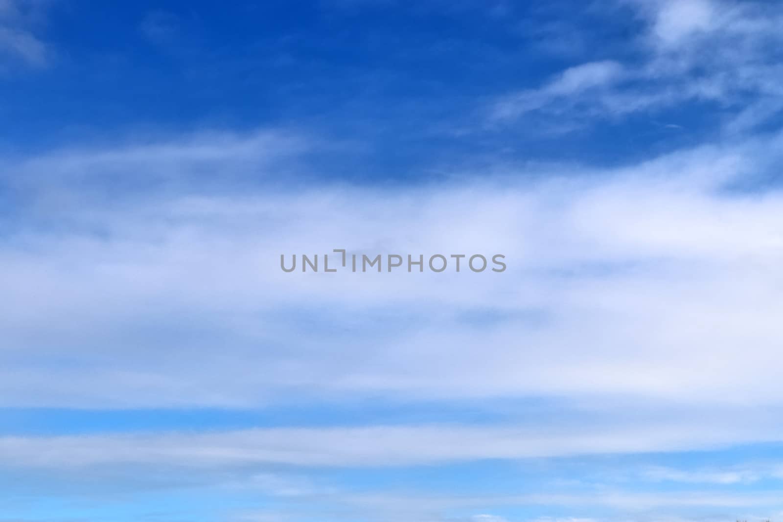 Beautiful fluffy white beautiful cloud formations in a deep blue summer sky