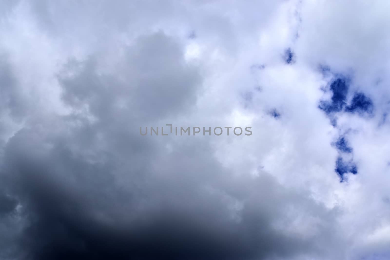 Beautiful fluffy white beautiful cloud formations in a deep blue summer sky