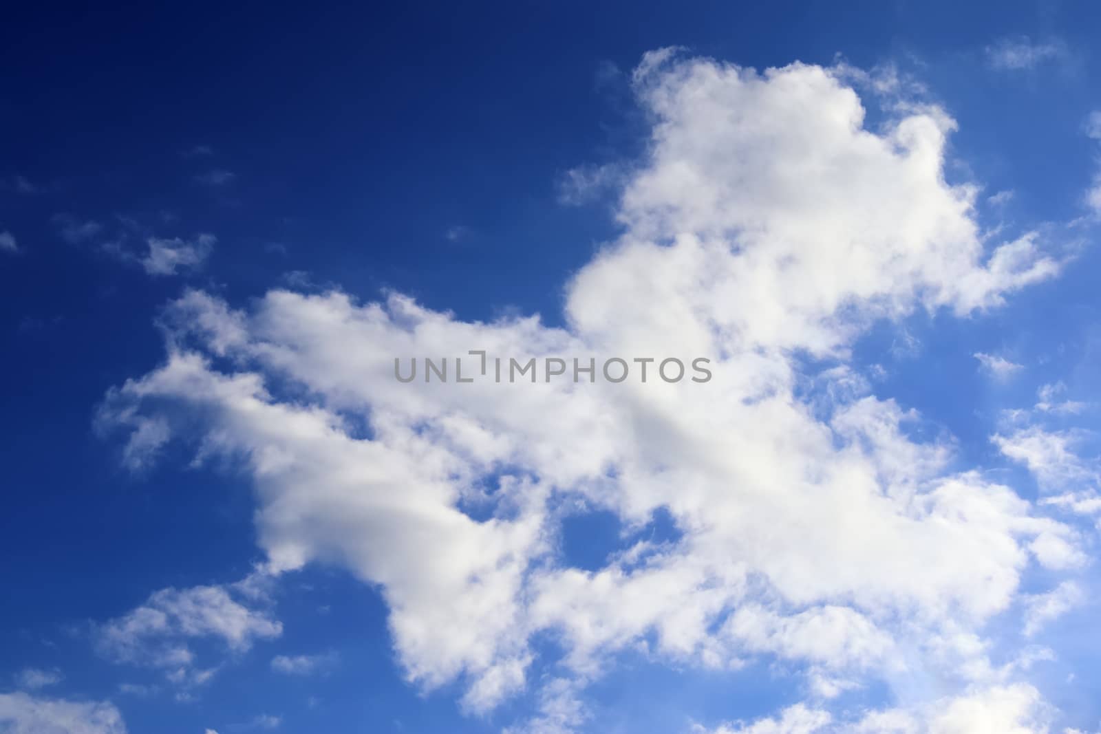 Beautiful fluffy white beautiful cloud formations in a deep blue summer sky