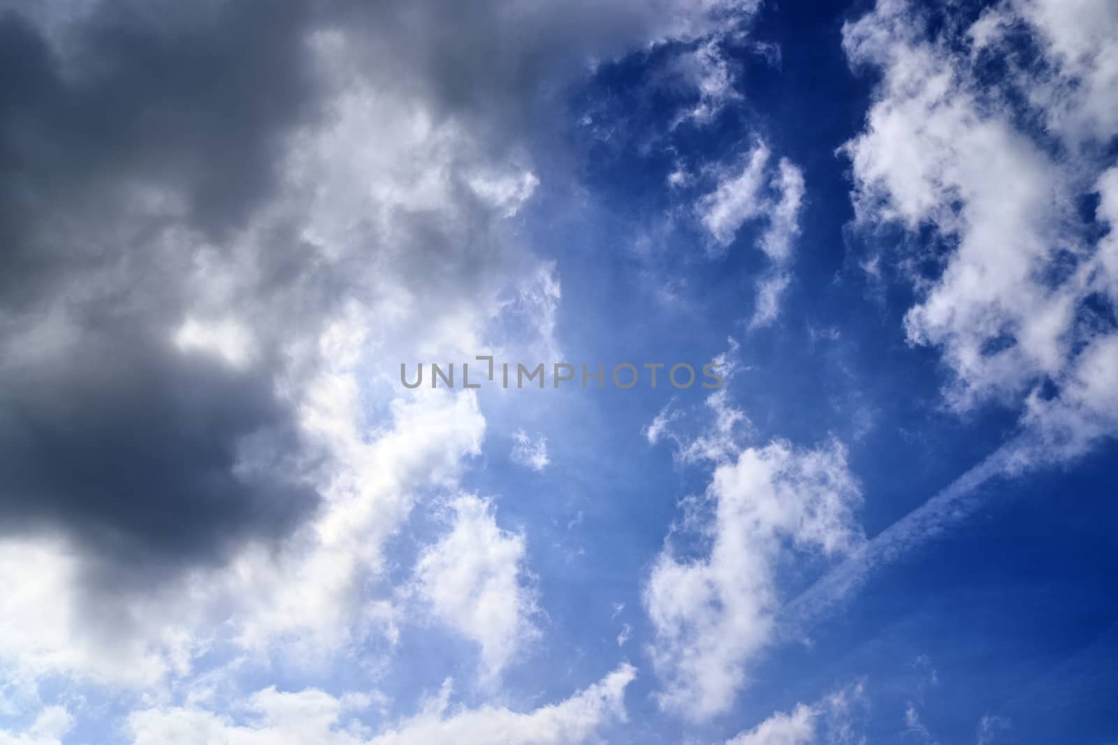 Beautiful fluffy white beautiful cloud formations in a deep blue summer sky