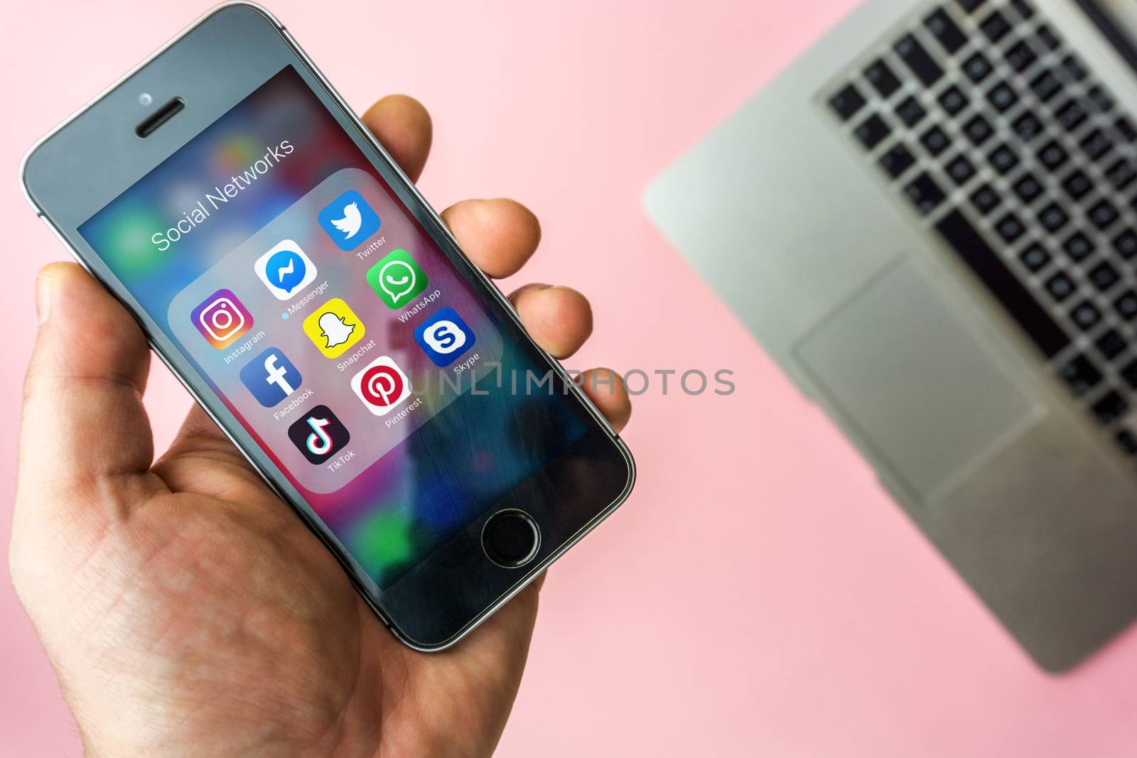 Vienna Austria - March.20 2019, Woman holding Apple SE with icon by MysteryShot