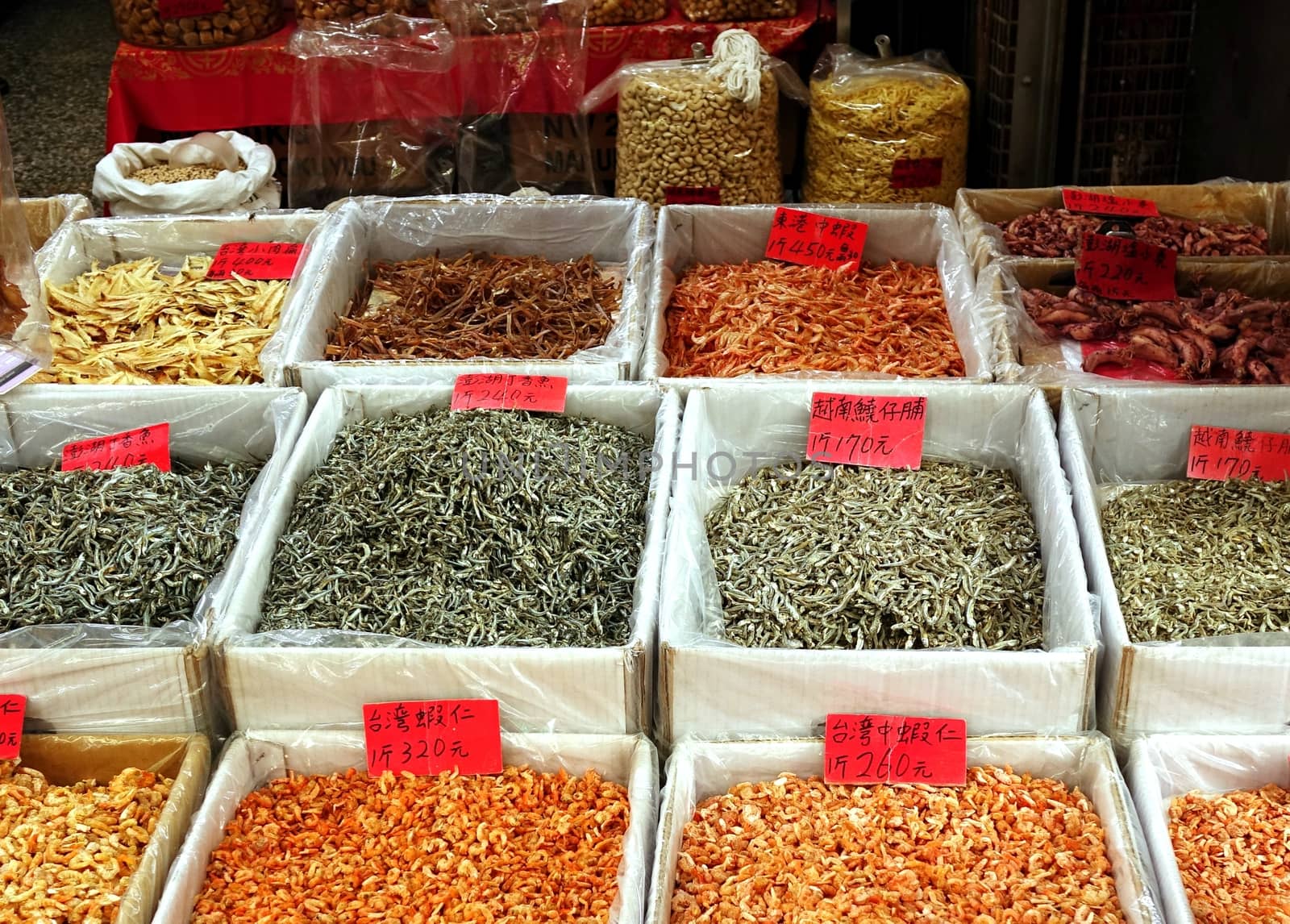 A Chinese vendor sells dried seafood in boxes
