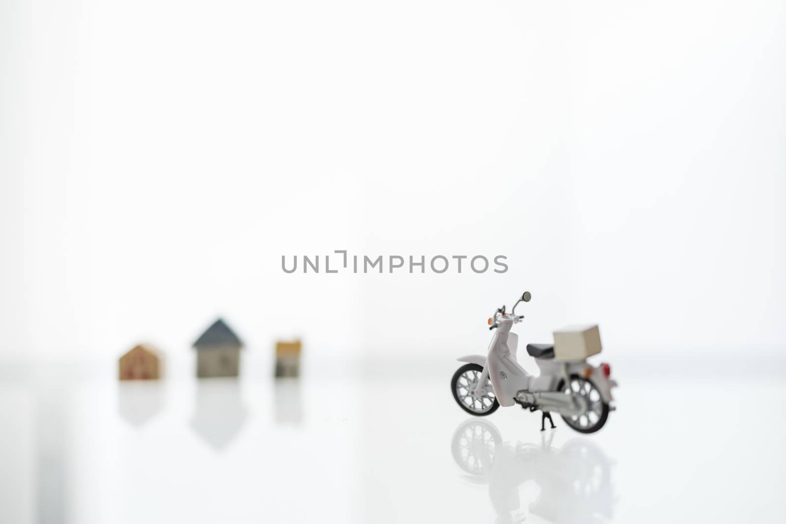 Stay home, Shelter in Place with Delivery and shopping online Concept. Close up of scotter / Motorcycle with container box and mini house as background.