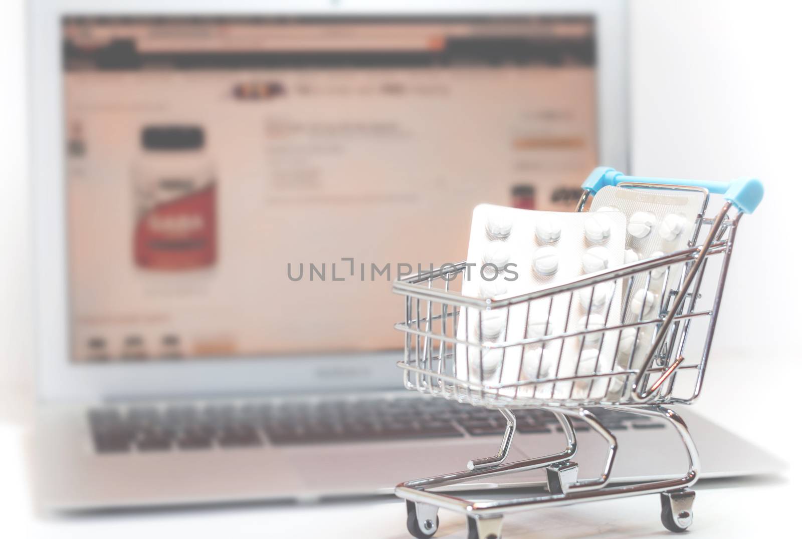 Vienna Austria March.30 2018,Online supplements shopping concept, shopping-cart placed on laptop isolated