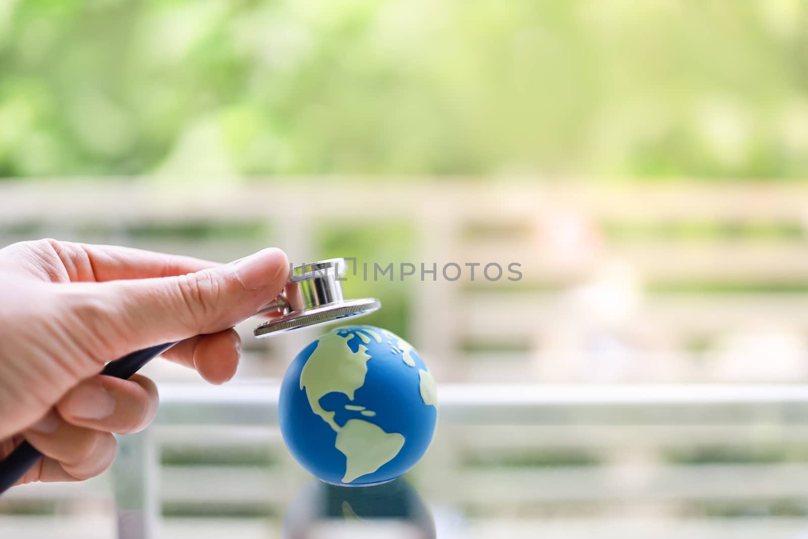 Global Healthcare and cure concept. Closeup of man hand holding  by mthipsorn