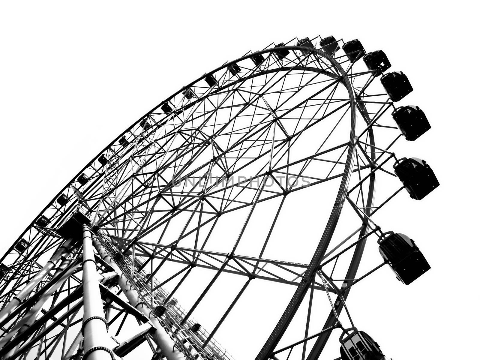 A ferris wheel at a local fun fair seen in silhouette