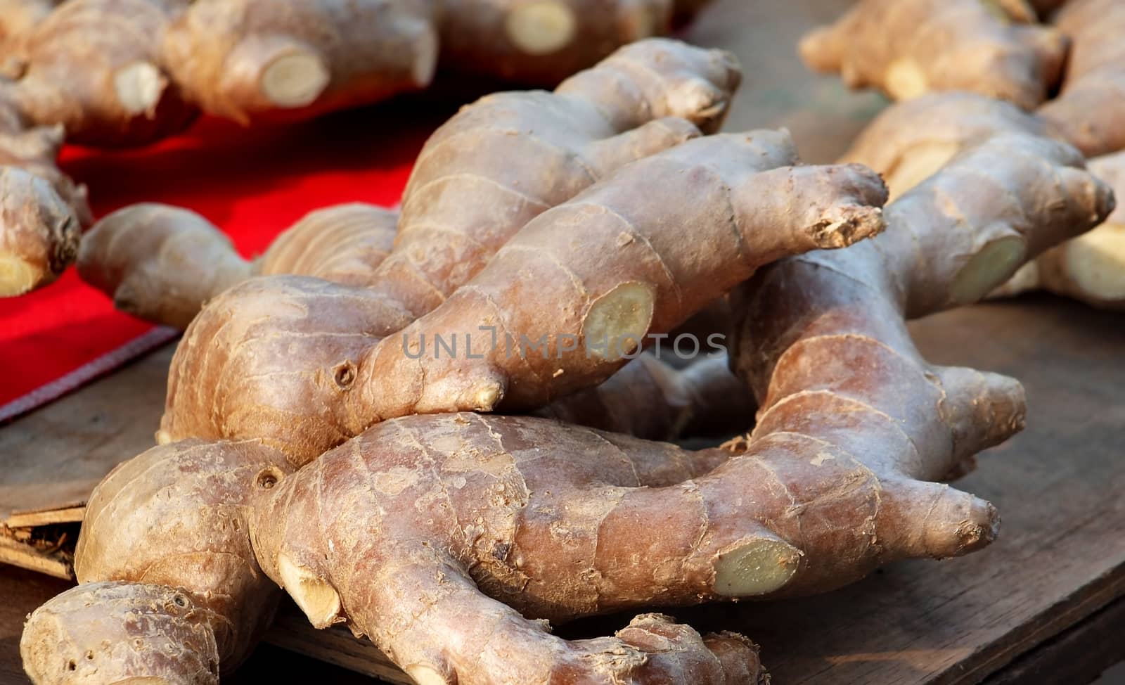 Fully grown ginger roots on display at a market stall
