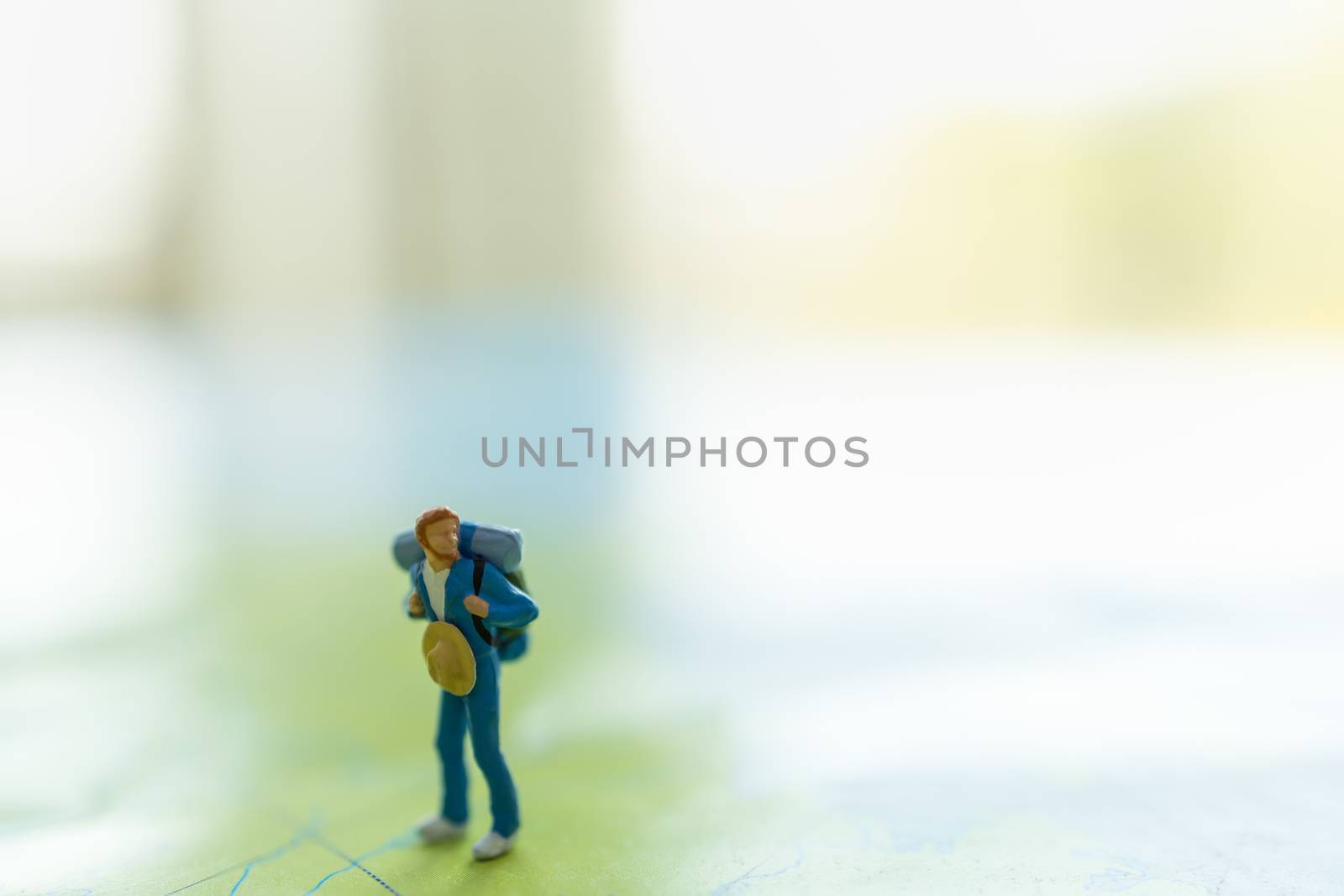 Travel concepts. Traveler miniature figures people with backpack by mthipsorn