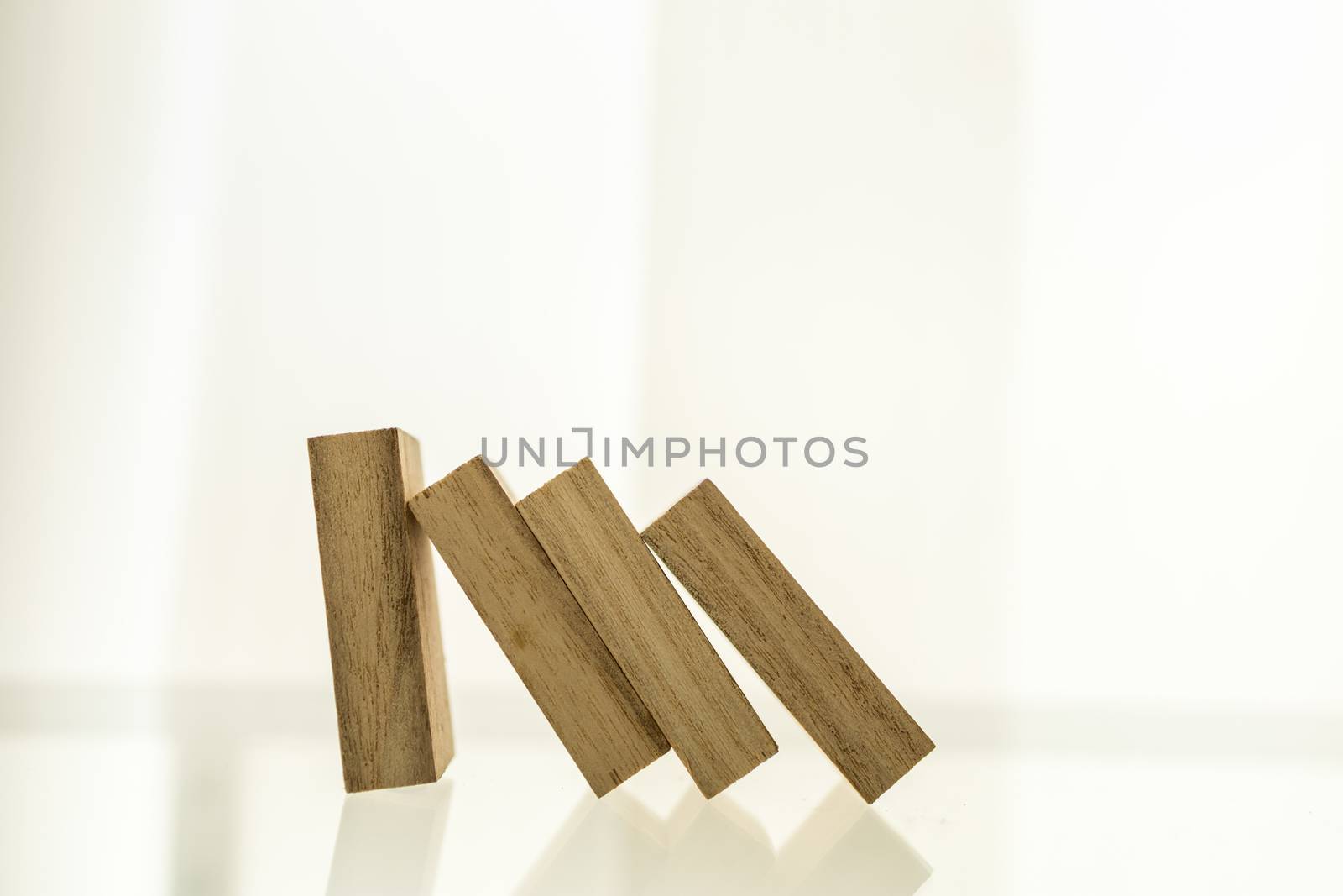 Crisis and failure in Business, Insurance and Risk Management Concept. Close up of wooden block standing and the collapse of fall in line, with copy space.
