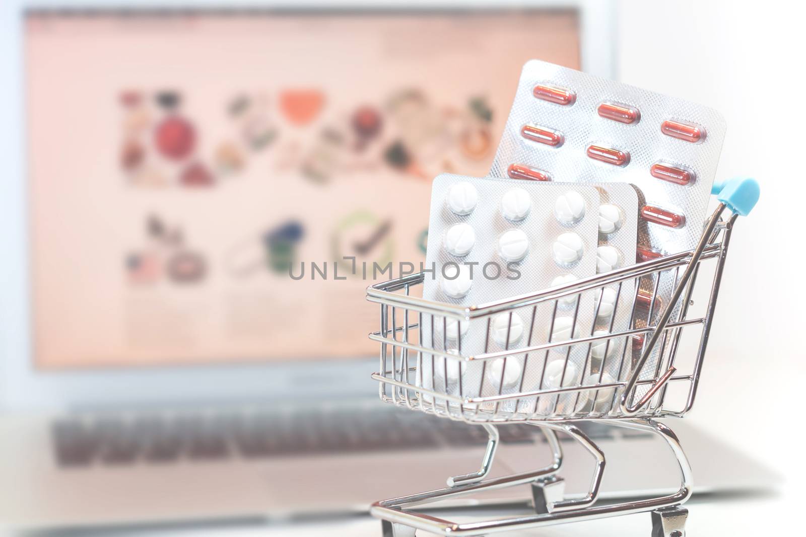 Vienna Austria March.30 2018, Online supplements pharmaceutical shopping concept, shopping-cart placed on laptop isolated