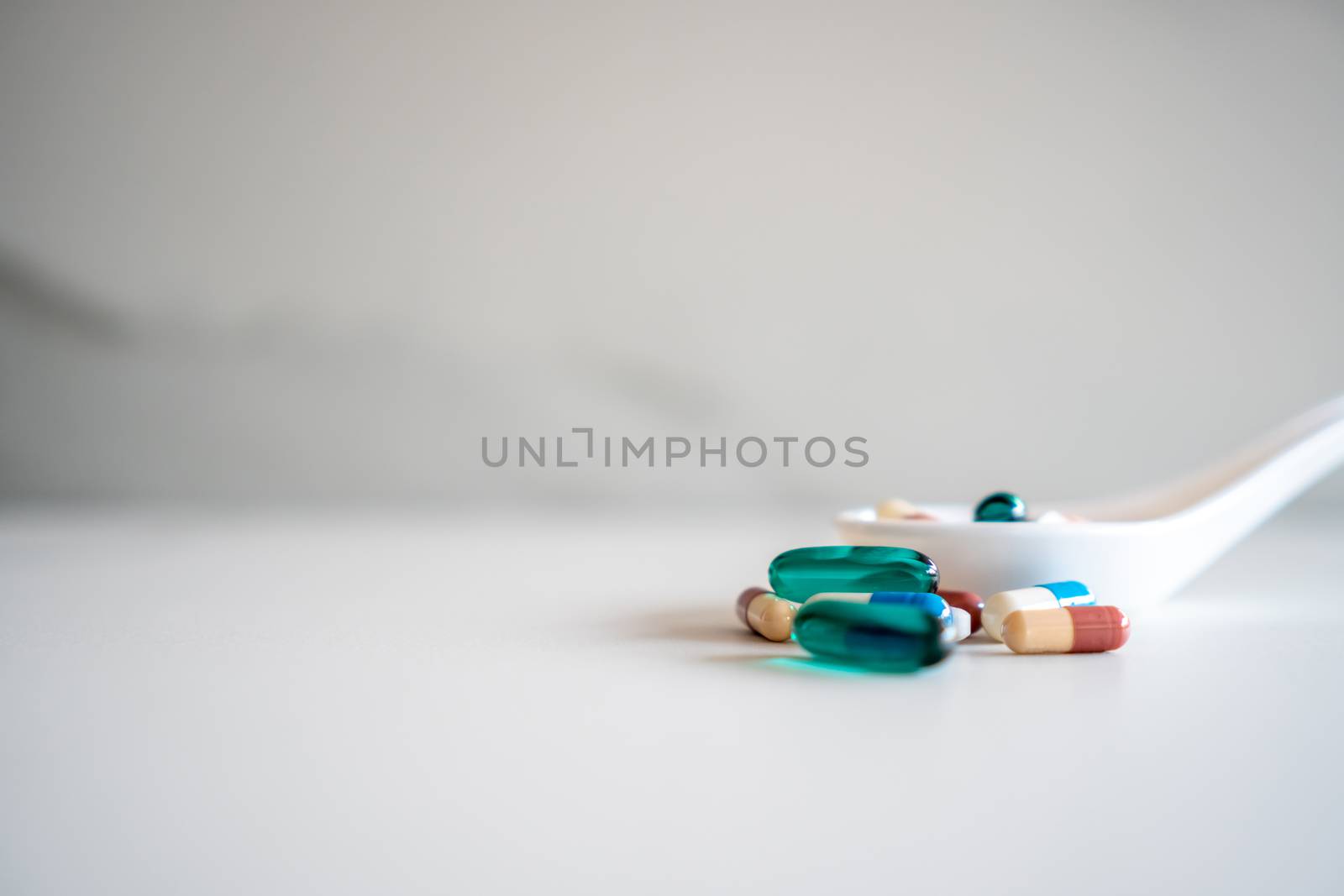 Mixed of pill or tablet medicine on white spoon on white background. Health care medicine cure disease lifestyle trend concept.