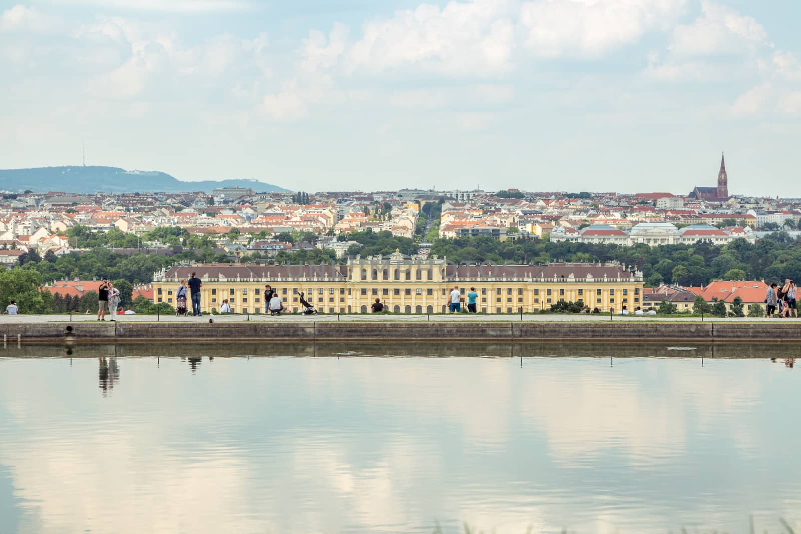 Vienna Austria May.10 2018, Schonbrunn castle view from Gloriette at low with the pond reflecting the sky against cityscape