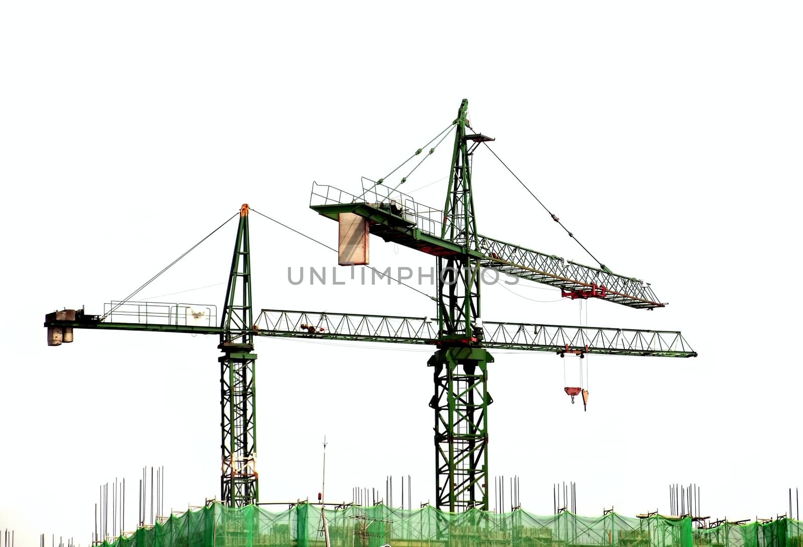 Large cranes at the top of a highrise construction project
