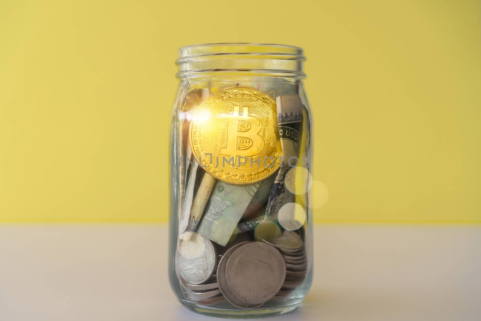 Bitcoin the jar full of coin and bank notes meaning of saving investment with cryptocurrency digital money fintech online network. Business technology concept.