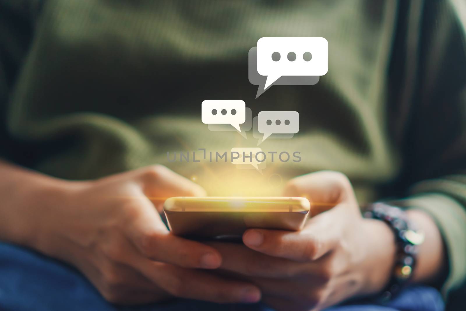 Women hand using smartphone typing, chatting conversation in chat box icons pop up. Social media maketing technology concept.Vintage soft color tone background.