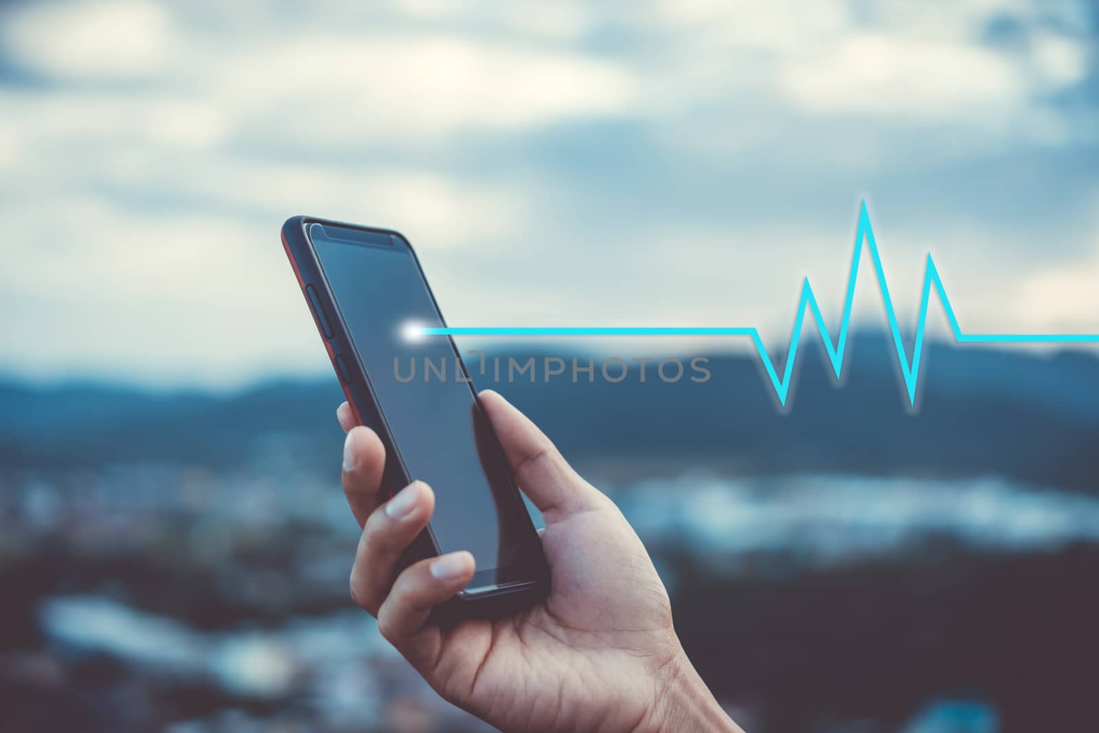 Woman hand holding smartphone with vital sign of heart beat background. Business technology health connection concept.