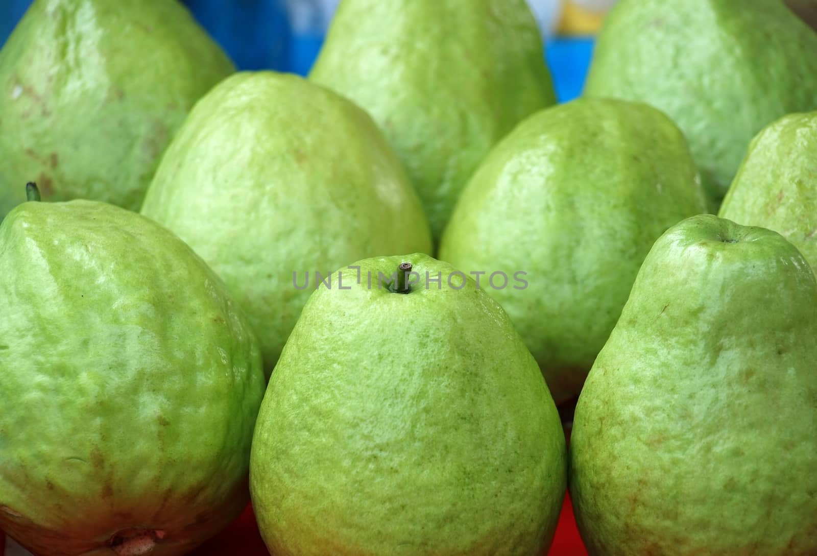 Green apple guavas for sale at an outdoor market