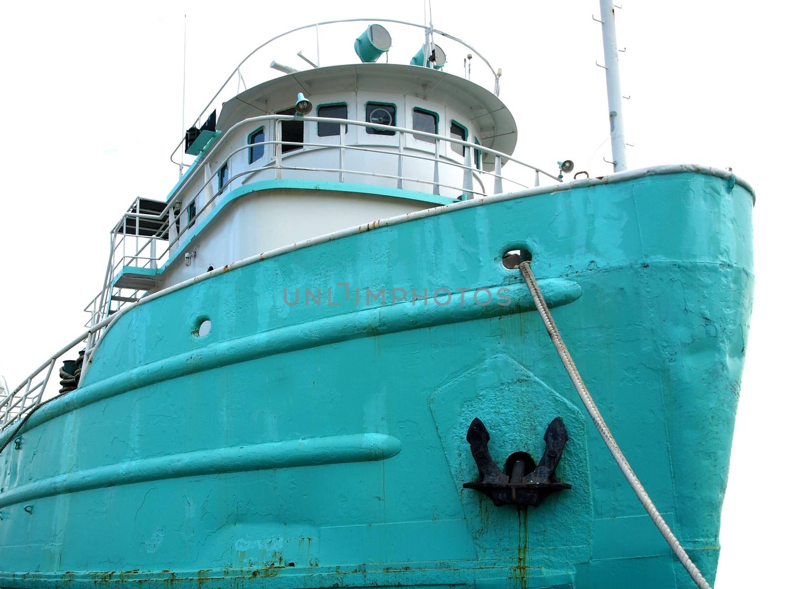 A vintage Chinese fishing boat is anchored in port