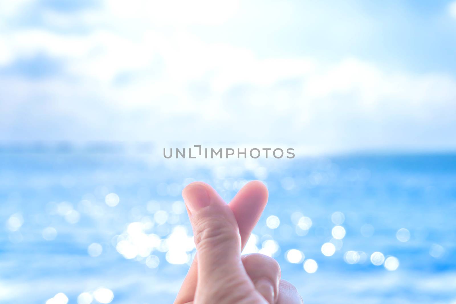 Love symbol of korean with your fingers. A female hand depicts a heart. by Suwant