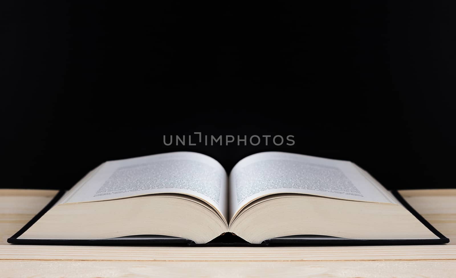 Book on blackboard background and copy space, education concept