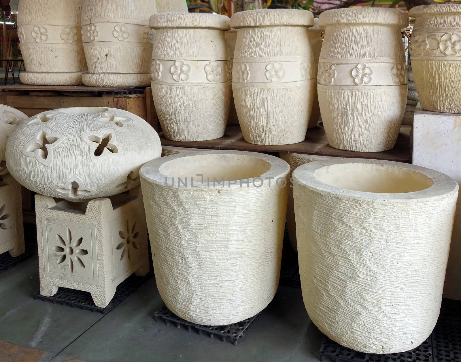 Large ceramic flower pots for sale at an outdoor market
