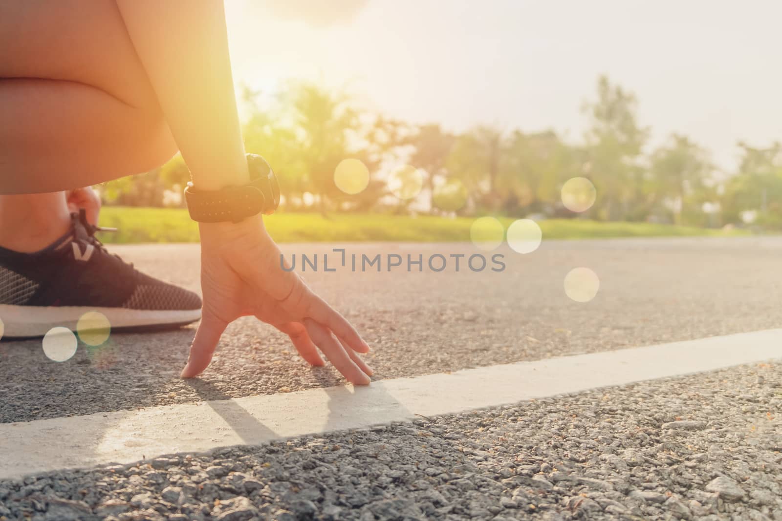 Woman wear running shoe on to walking and running on nature green background.Health exercise. by Suwant