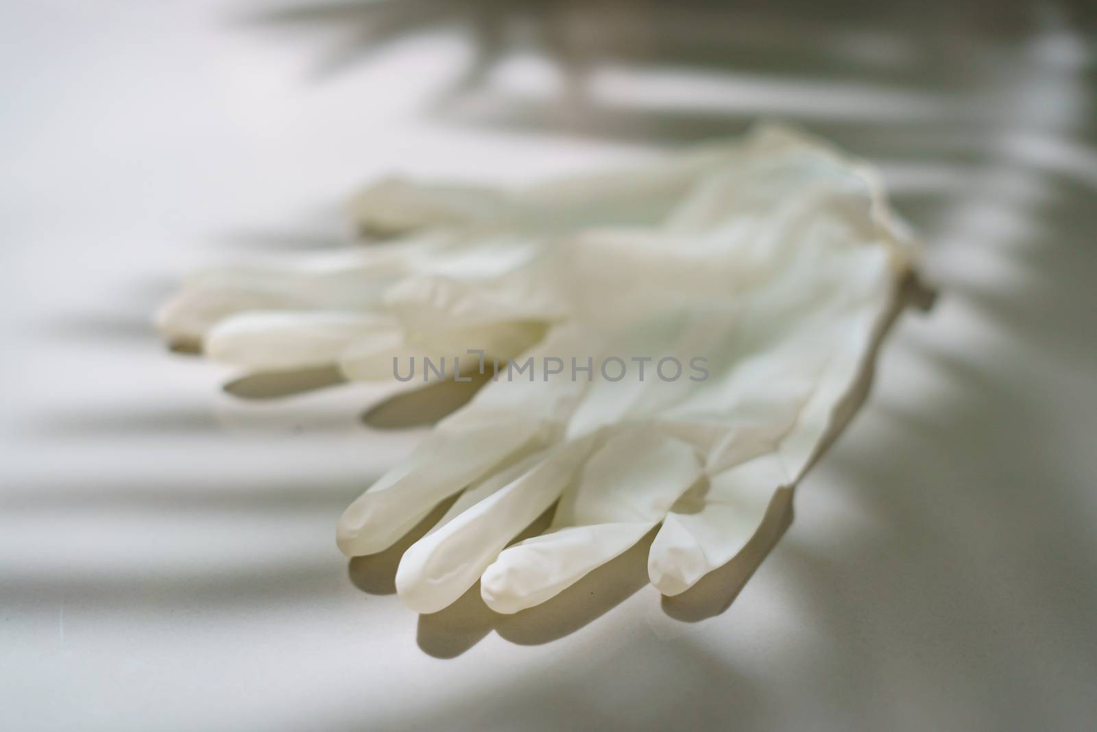 Pair of white latex medical gloves