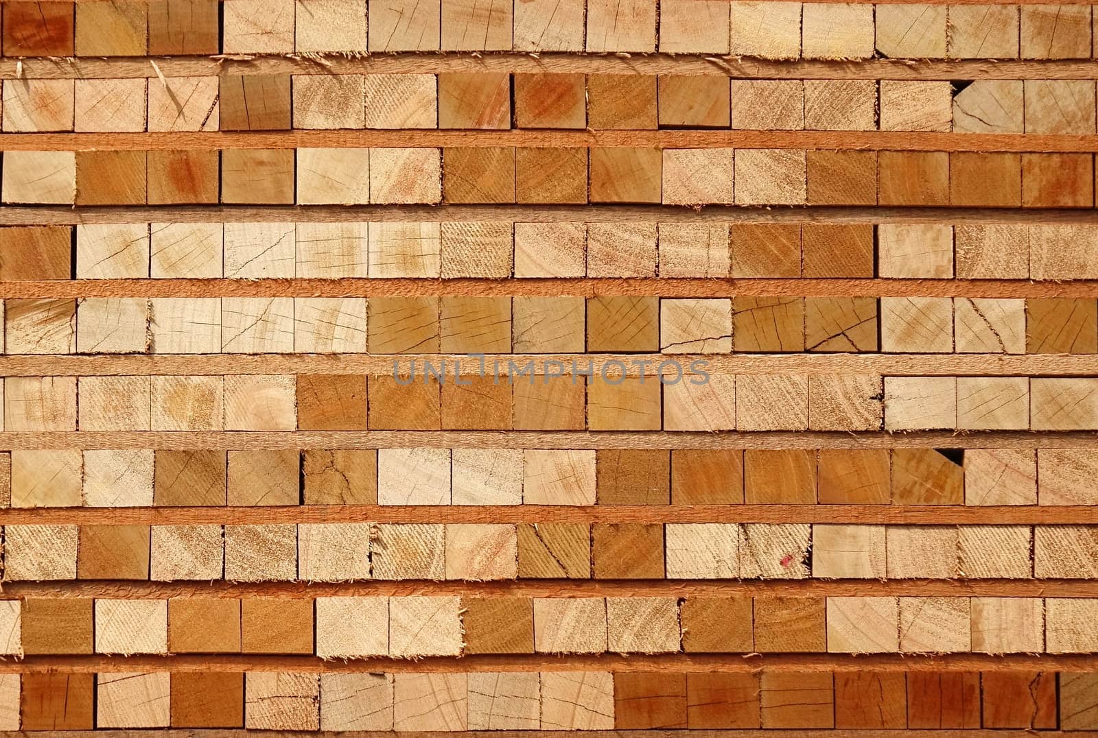 Wooden boards and beams are stacked at a lumber yard
