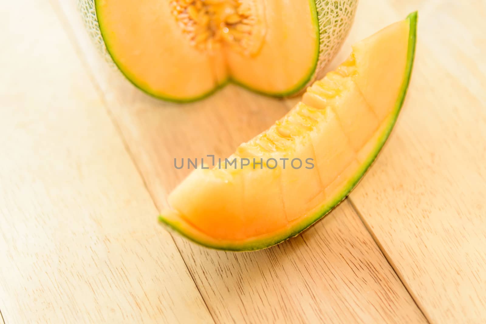 Fresh Orange melon on wood plate by rukawajung