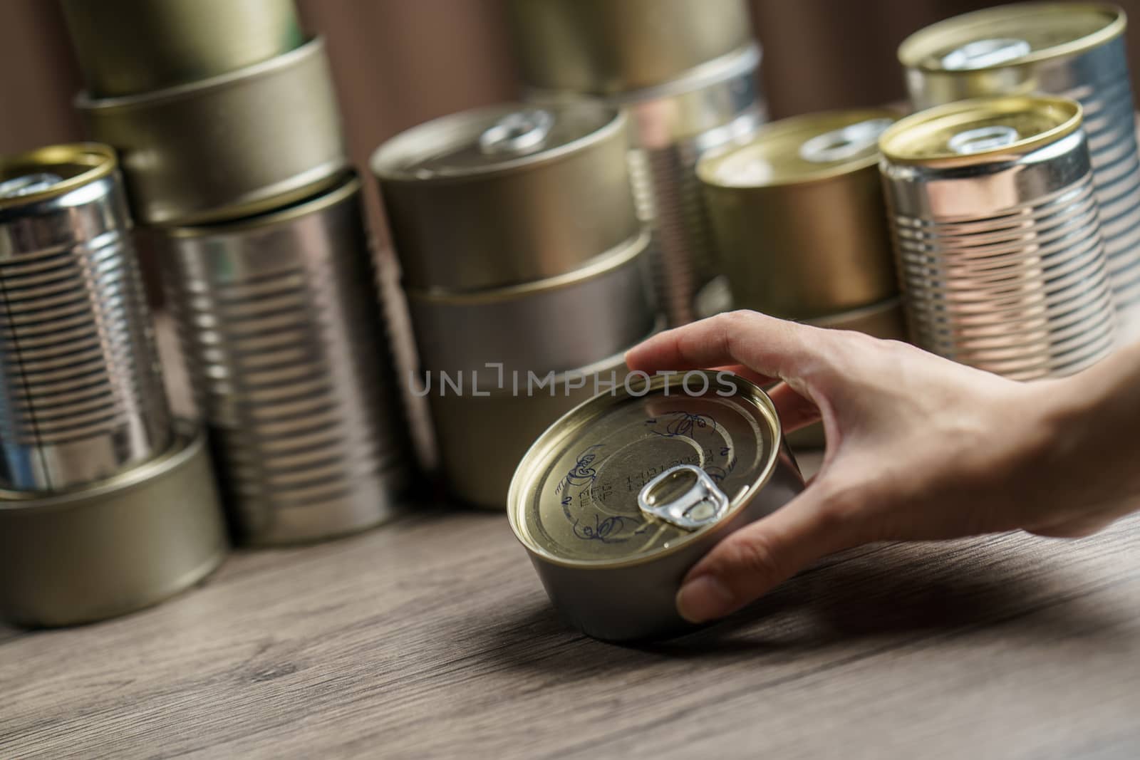 Woman hand with group of Aluminium canned food.