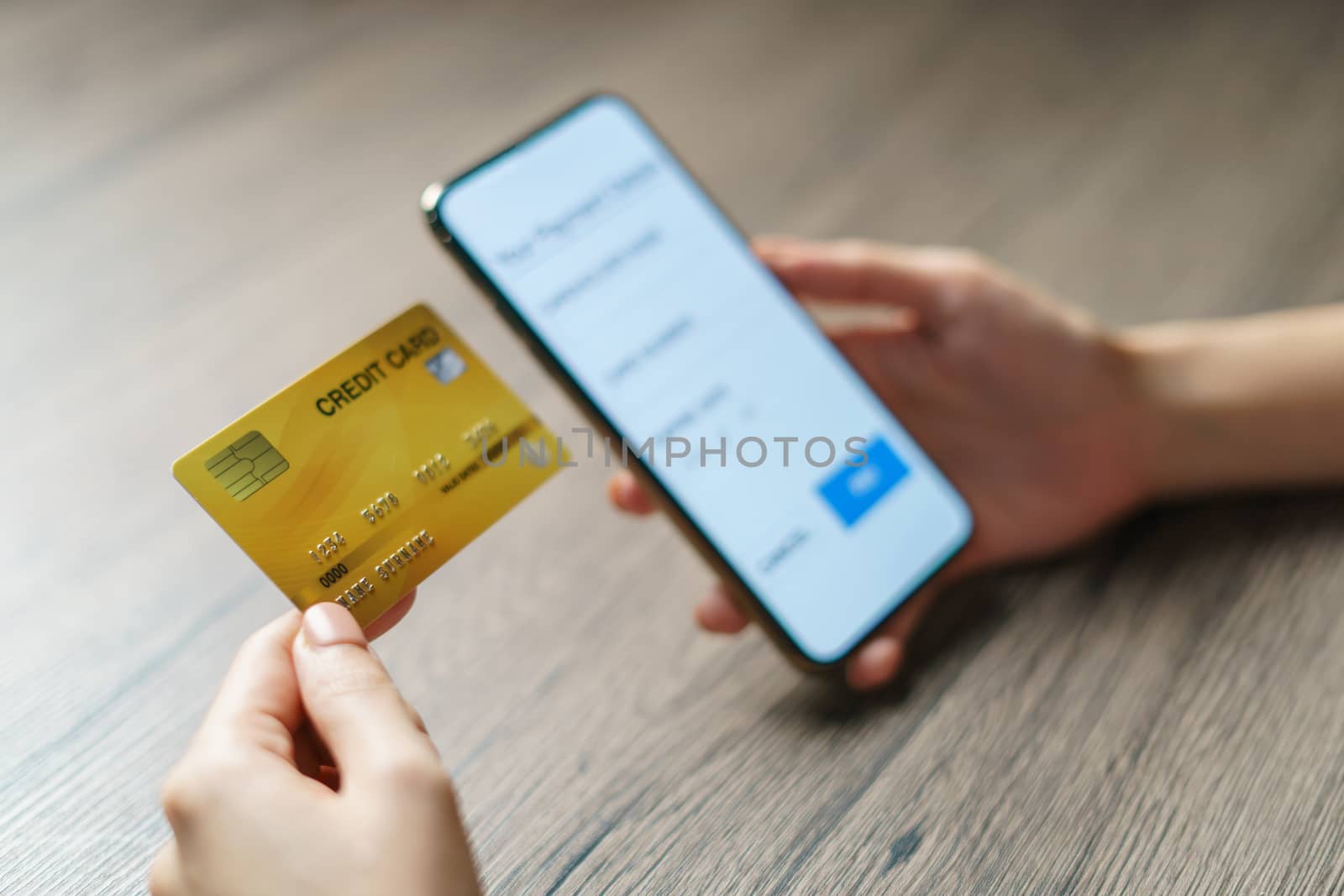 Mobile payments. hands using smartphone and credit card for online shopping.