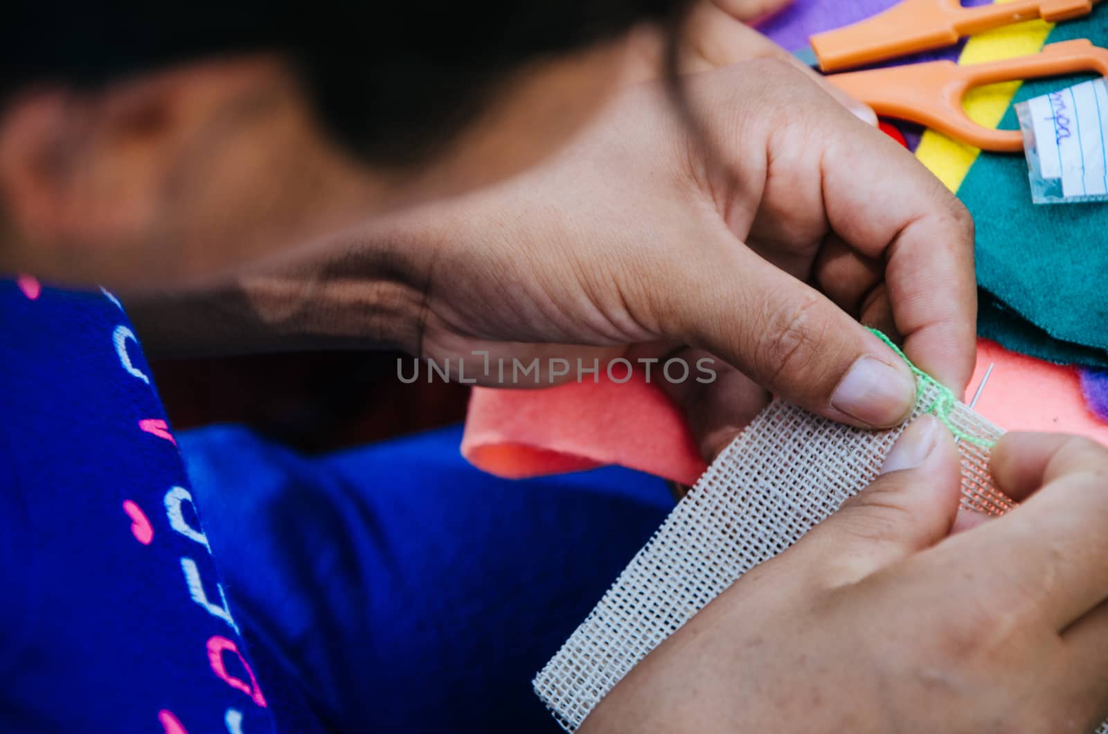 Hands of a woman knitting with a needle