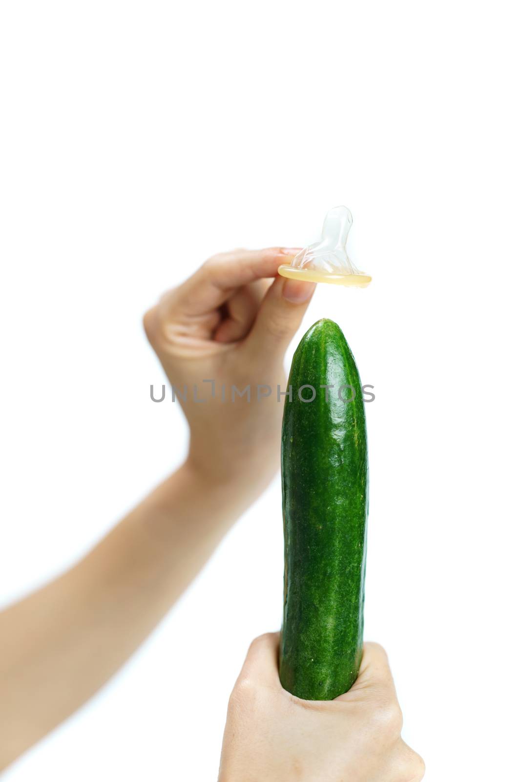 Woman hand hold cucumber with condom on white background. isolated