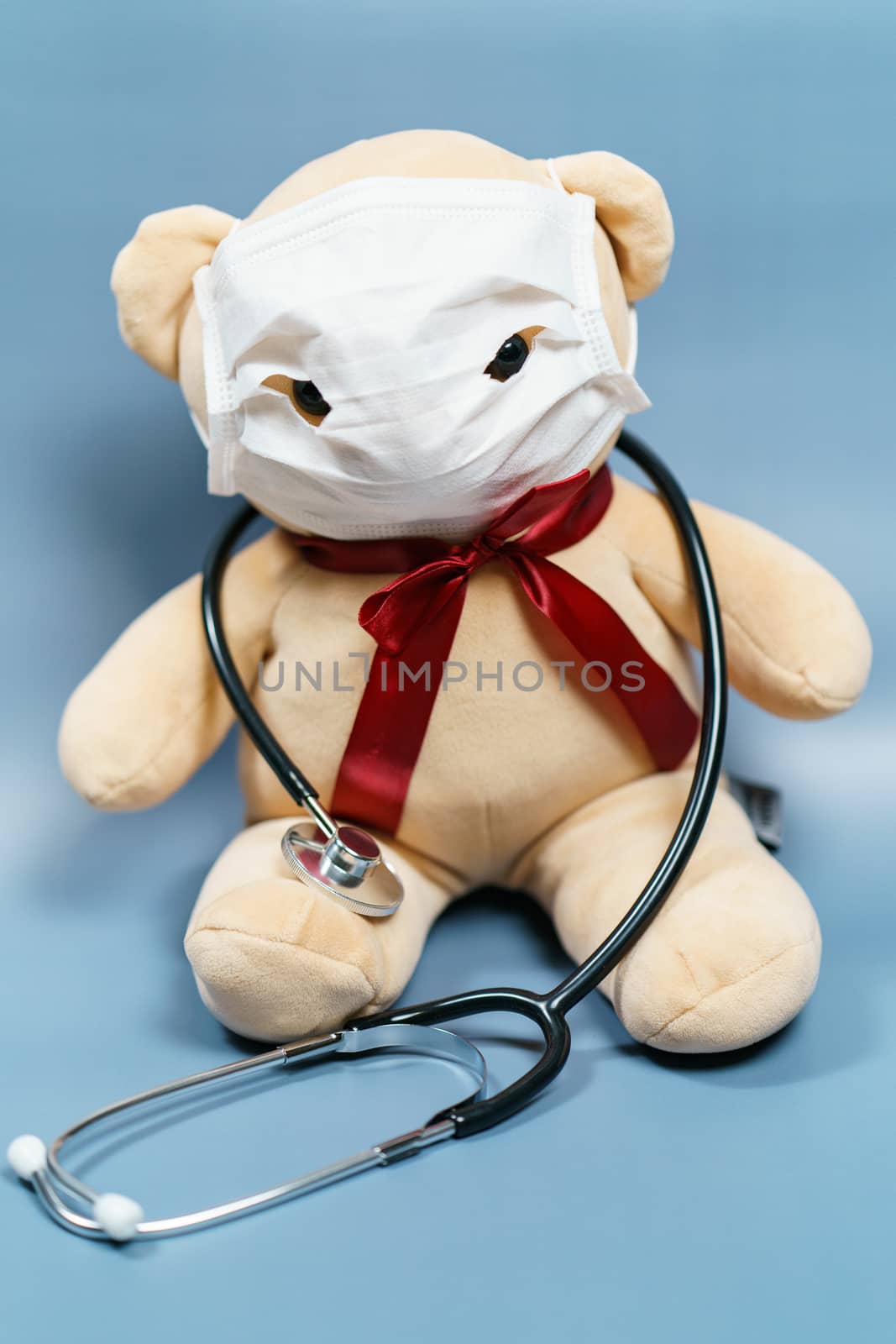 Teddy bear wearing mask and stethoscope. Coronavirus covid-19 and protection concept.