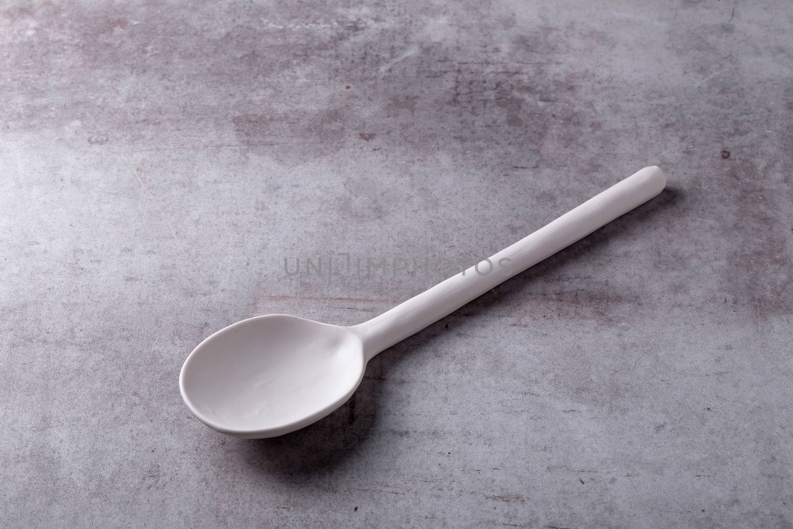 Empty blank white spoon ceramic on Cement Board by kaiskynet