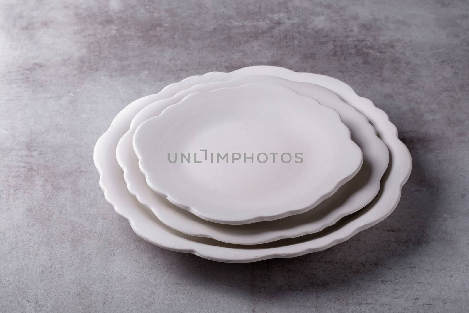 Empty blank white ceramic dish on Cement Board by kaiskynet