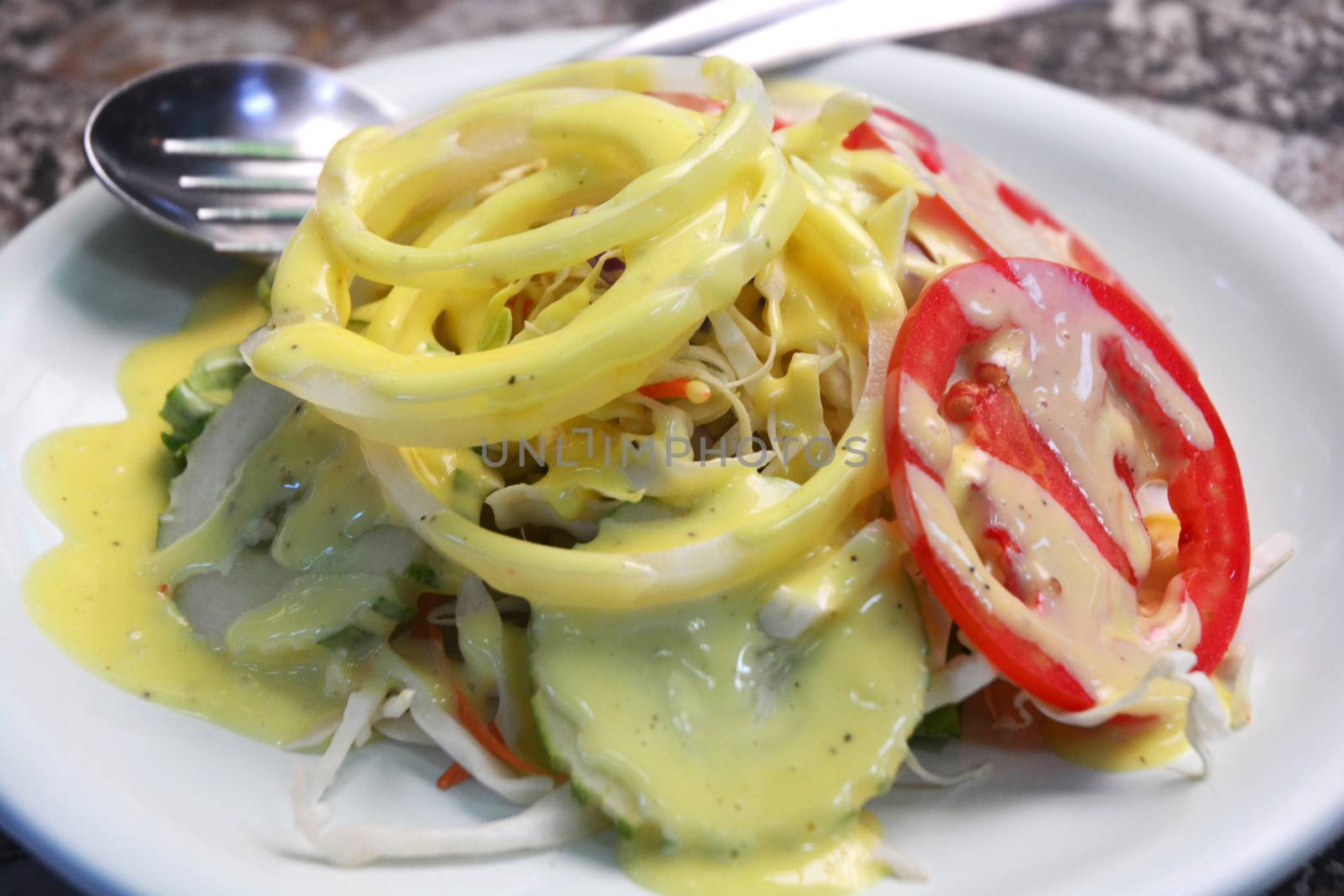 Salad topped with salad dressing by ideation90