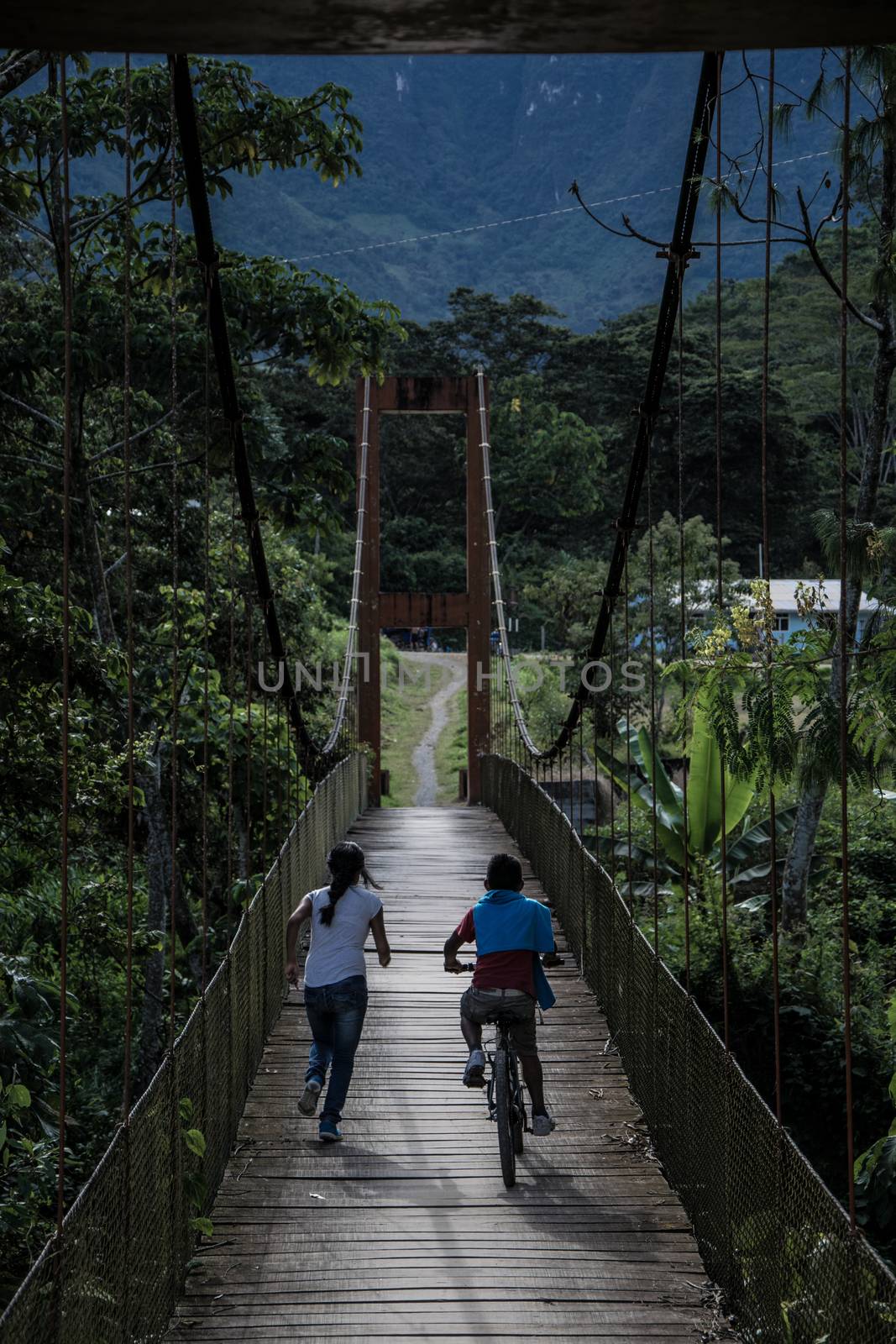 Children crossing the La Cañera pedestrian bridge located in Oxapampa - Peru
